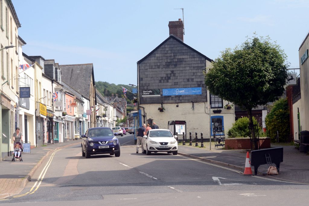 New Street in Honiton with union flags flying from various buildings.